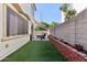 Outdoor living space features artificial grass, brick planter, fire pit and shade sails at 6641 N Desert Shadow Ln, Phoenix, AZ 85014
