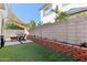 Spacious backyard featuring artificial turf, shade sails, brick accents and outdoor seating area at 6641 N Desert Shadow Ln, Phoenix, AZ 85014