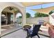 Outdoor living space offering a covered patio, artificial turf, shade sails, fire pit and seating at 6641 N Desert Shadow Ln, Phoenix, AZ 85014