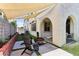 Landscaped backyard with patio featuring shade sails, outdoor seating, and a cozy fire pit at 6641 N Desert Shadow Ln, Phoenix, AZ 85014