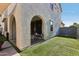 Artificial turf in backyard, with covered patio, fire pit, and arched openings at 6641 N Desert Shadow Ln, Phoenix, AZ 85014
