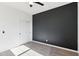 Bedroom with neutral carpet, black accent wall, and closet doors at 6641 N Desert Shadow Ln, Phoenix, AZ 85014