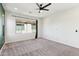Bright, spacious bedroom featuring neutral carpet, large windows, and modern ceiling fan at 6641 N Desert Shadow Ln, Phoenix, AZ 85014