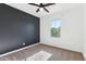 Modern bedroom features a dark accent wall, carpet floors, and a window for natural light at 6641 N Desert Shadow Ln, Phoenix, AZ 85014