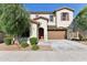 Charming two-story home featuring a front yard, desert landscaping and a two car garage at 6641 N Desert Shadow Ln, Phoenix, AZ 85014