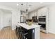 Kitchen with white cabinets, black countertops, stainless appliances and an island with barstool seating at 6641 N Desert Shadow Ln, Phoenix, AZ 85014