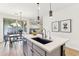 Stylish kitchen island with seating and modern pendant lighting fixtures at 6641 N Desert Shadow Ln, Phoenix, AZ 85014