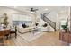 Bright, open living room features stylish decor, ceiling fan, and staircase access at 6641 N Desert Shadow Ln, Phoenix, AZ 85014