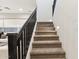 Carpeted staircase with dark wooden railing and accent lighting for a modern look at 6641 N Desert Shadow Ln, Phoenix, AZ 85014