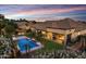 Backyard featuring a pristine pool, manicured lawn, and stylish patio area perfect for outdoor living at 6918 E Ivyglen St, Mesa, AZ 85207