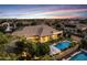 Aerial view of home highlighting a beautiful backyard pool, lush landscaping, and patio area at 6918 E Ivyglen St, Mesa, AZ 85207