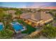 Spacious single-Gathering home with a private pool area, complemented by lush greenery and outdoor seating at 6918 E Ivyglen St, Mesa, AZ 85207