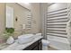 Contemporary bathroom featuring vessel sink on vanity, decorative mirror, and stylish shower curtain at 6918 E Ivyglen St, Mesa, AZ 85207