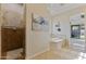 Bathroom suite showcasing a neutral color palette, tiled walk-in shower, soaking tub, and backyard views at 6918 E Ivyglen St, Mesa, AZ 85207