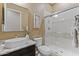 Well-lit bathroom featuring a modern vanity and glass-enclosed shower with decorative tile at 6918 E Ivyglen St, Mesa, AZ 85207