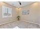 Well-lit bedroom with a ceiling fan, large window with shutters, and neutral wall decor at 6918 E Ivyglen St, Mesa, AZ 85207