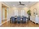 A bright dining space featuring wood-look tile floors, a modern table setting, and neutral decor for elegant meals at 6918 E Ivyglen St, Mesa, AZ 85207
