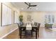 Open dining area with a stylish table set, modern lighting, and a cozy sitting area near the bright window at 6918 E Ivyglen St, Mesa, AZ 85207