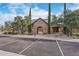 Stone community entrance with arched entryway, porte-cochere, and parking at 6918 E Ivyglen St, Mesa, AZ 85207