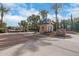 Gated community entrance with stone signage and flower beds at 6918 E Ivyglen St, Mesa, AZ 85207