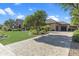 Beautiful home exterior with a stone facade, manicured landscaping, and a brick driveway at 6918 E Ivyglen St, Mesa, AZ 85207