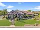 Beautiful single-Gathering home with lush front yard and stone facade at 6918 E Ivyglen St, Mesa, AZ 85207
