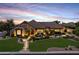Beautiful front exterior showcasing a stone-accented facade, mature trees, and a serene water feature at 6918 E Ivyglen St, Mesa, AZ 85207