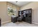 Well-appointed home office with built-in bookcase, desk, and window overlooking the greenery outside at 6918 E Ivyglen St, Mesa, AZ 85207