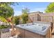 Relaxing hot tub in a private backyard oasis with lush landscaping and a privacy fence at 6918 E Ivyglen St, Mesa, AZ 85207