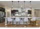 Well-equipped kitchen with stainless appliances, center island, and stylish pendant lighting at 6918 E Ivyglen St, Mesa, AZ 85207