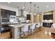 Modern kitchen boasting stainless steel appliances, a large island with seating, and ample cabinet space for storage at 6918 E Ivyglen St, Mesa, AZ 85207