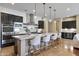 Well-appointed kitchen features large island with bar seating, stainless appliances, and custom cabinetry at 6918 E Ivyglen St, Mesa, AZ 85207
