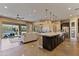 Spacious, open-concept kitchen featuring granite countertops, stainless appliances, and a seamless flow to living area at 6918 E Ivyglen St, Mesa, AZ 85207