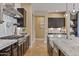 Updated kitchen with stainless steel appliances, marble counters, gas range, and open layout perfect for cooking at 6918 E Ivyglen St, Mesa, AZ 85207