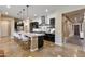 Modern kitchen with granite island, pendant lighting, stainless steel appliances, and dark cabinets for a gourmet feel at 6918 E Ivyglen St, Mesa, AZ 85207