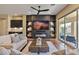 A modern living room boasts built-in shelves, a fireplace, and a sliding glass door to the outside at 6918 E Ivyglen St, Mesa, AZ 85207