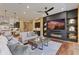 Inviting living room with a modern fireplace, built-in shelving, and an open flow from the kitchen for entertainment at 6918 E Ivyglen St, Mesa, AZ 85207