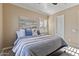 Relaxing main bedroom with a comfortable bed, neutral color scheme, and bright window at 6918 E Ivyglen St, Mesa, AZ 85207