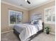 Cozy main bedroom with a plush bed, neutral decor, and natural light from shuttered windows at 6918 E Ivyglen St, Mesa, AZ 85207