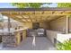 Outdoor kitchen features built-in grill, stone accents, ample counter space and cabinets for storage, perfect for entertaining at 6918 E Ivyglen St, Mesa, AZ 85207