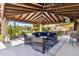 Inviting covered patio with comfortable seating, outdoor kitchen, and lush landscaping, perfect for relaxing and entertaining at 6918 E Ivyglen St, Mesa, AZ 85207
