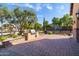 Charming brick patio with built in grill, and outdoor play areas: playground and basketball court at 6918 E Ivyglen St, Mesa, AZ 85207