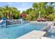 Refreshing pool area with cascading water feature and surrounding tropical plants creating a tranquil oasis at 6918 E Ivyglen St, Mesa, AZ 85207