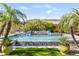 Beautiful pool with a cascading water feature and lush landscaping, perfect for outdoor entertaining and relaxation at 6918 E Ivyglen St, Mesa, AZ 85207