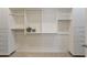 Large walk-in closet with custom storage solutions, including shelves, drawers, and hanging rods at 6918 E Ivyglen St, Mesa, AZ 85207