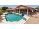 Inviting backyard with a refreshing pool, safety fence, covered patio, and ample space for outdoor enjoyment at 7701 E Portobello Ave, Mesa, AZ 85212