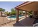 Covered patio overlooks the backyard swimming pool at 7701 E Portobello Ave, Mesa, AZ 85212