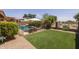 Landscaped backyard features artificial turf and a fenced swimming pool at 7701 E Portobello Ave, Mesa, AZ 85212