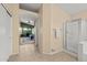Bright bathroom with glass-enclosed shower and tile floors, leading to the main bedroom at 7701 E Portobello Ave, Mesa, AZ 85212