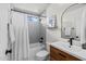 Bright bathroom featuring tub/shower, subway tile and wooden vanity cabinet at 7701 E Portobello Ave, Mesa, AZ 85212